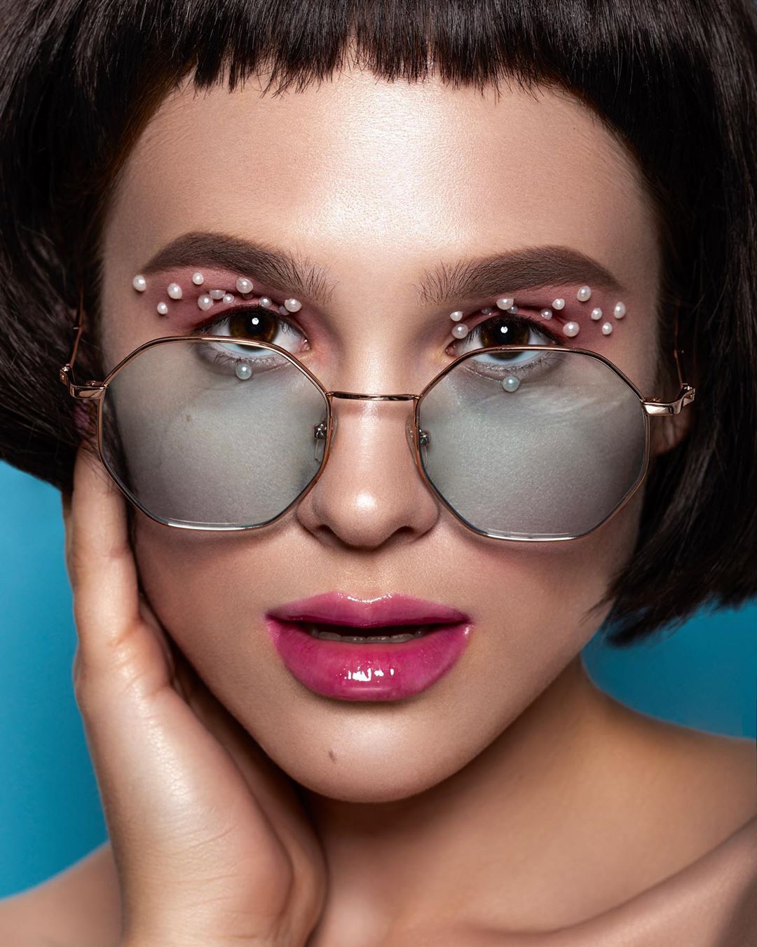 Lady With Creative Make Up In Sunglasses And Pearl Beads