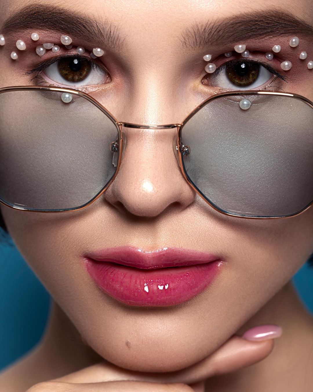 Lady With Creative Make Up In Sunglasses And Pearl Beads