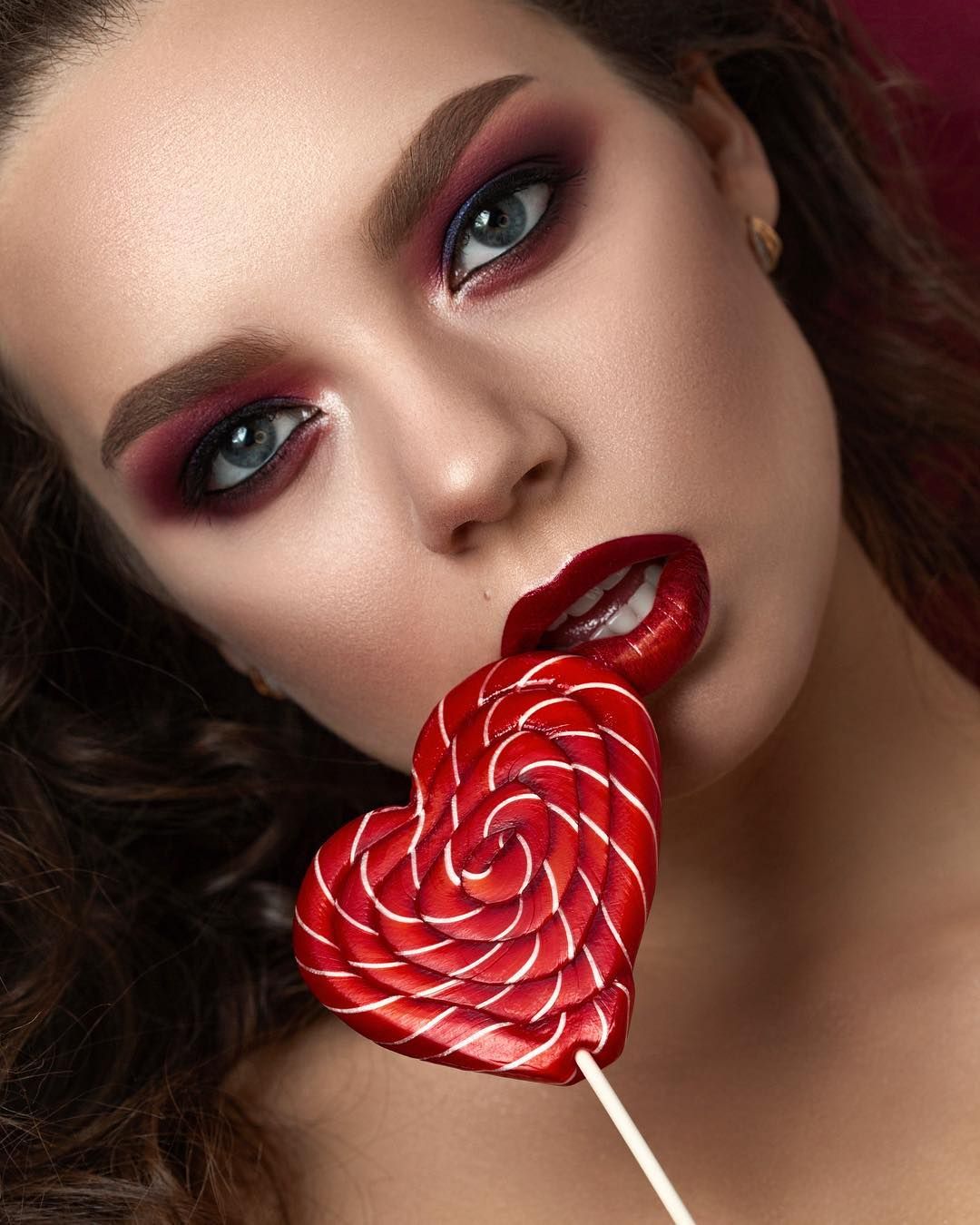 Lady With Creative Make Up And Red Heart Lollipop